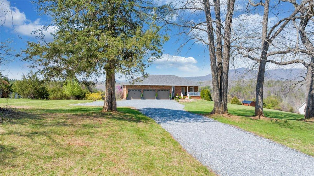 5129 Wheatland Road Bedford, VA 24523 - Photo 4 of 51 a view of a house with a yard and large trees