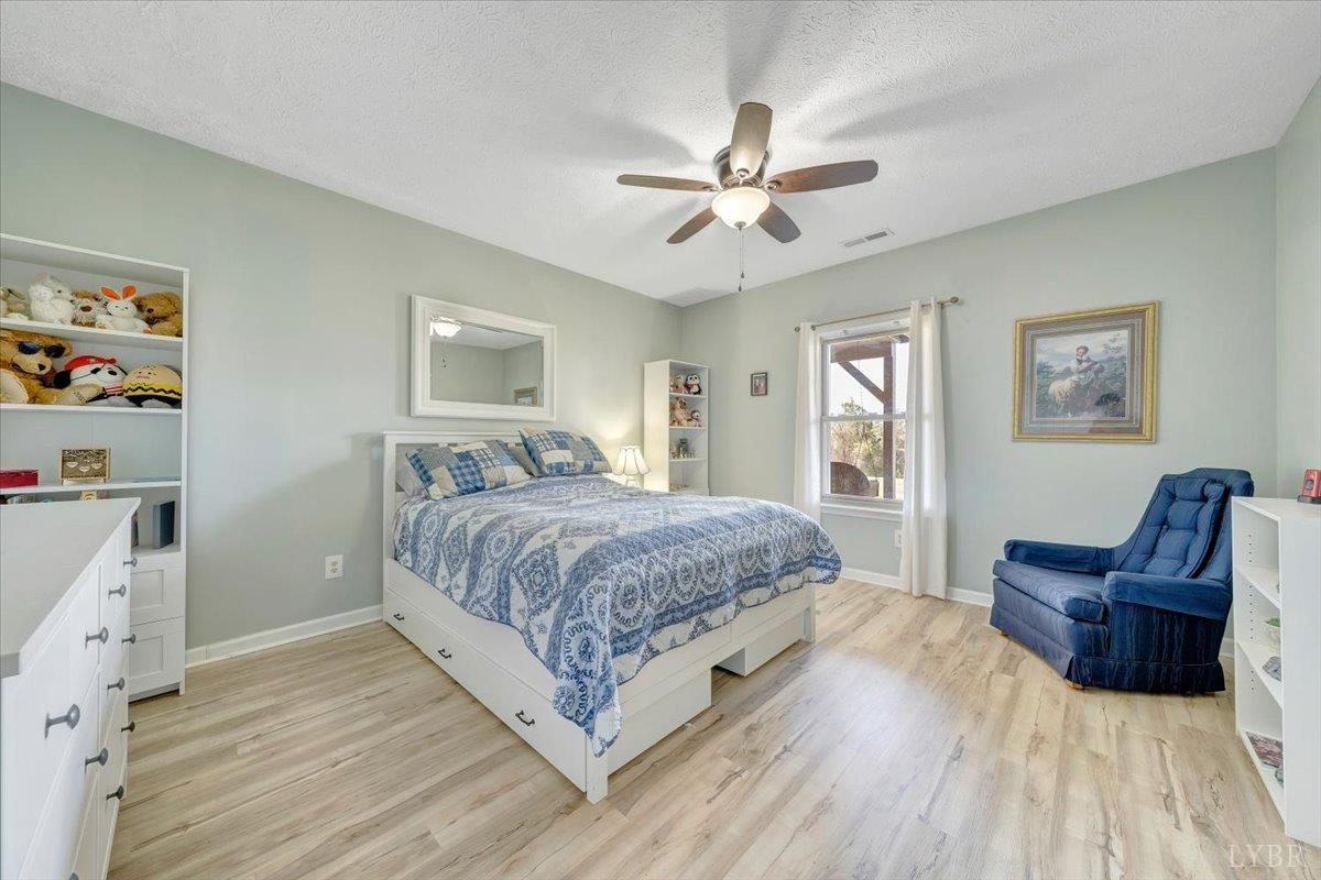 5129 Wheatland Road Bedford, VA 24523 - Photo 42 of 51 a spacious bedroom with a bed and a couch