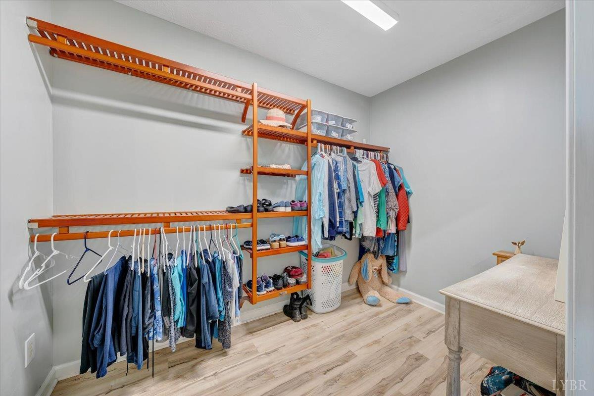 5129 Wheatland Road Bedford, VA 24523 - Photo 43 of 51 a view of walk in closet with clothes and shoes