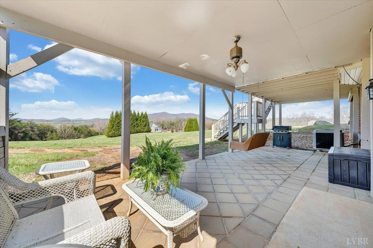 5129 Wheatland Road Bedford, VA 24523 - Photo 48 of 51 a living room with patio furniture and a floor to ceiling window