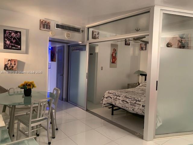 100 Lincoln Road, Unit 1509 Miami Beach, FL 33139 - Photo 4 of 32 a bedroom with a bed and a chair in it