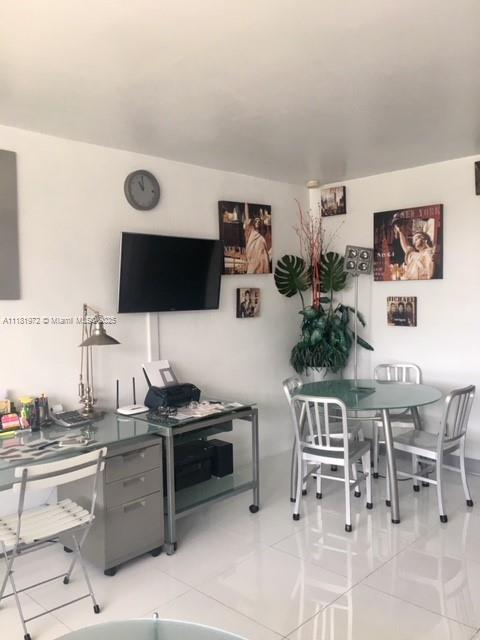 100 Lincoln Road, Unit 1509 Miami Beach, FL 33139 - Photo 7 of 32 a kitchen with stainless steel appliances kitchen island granite countertop a sink and cabinets