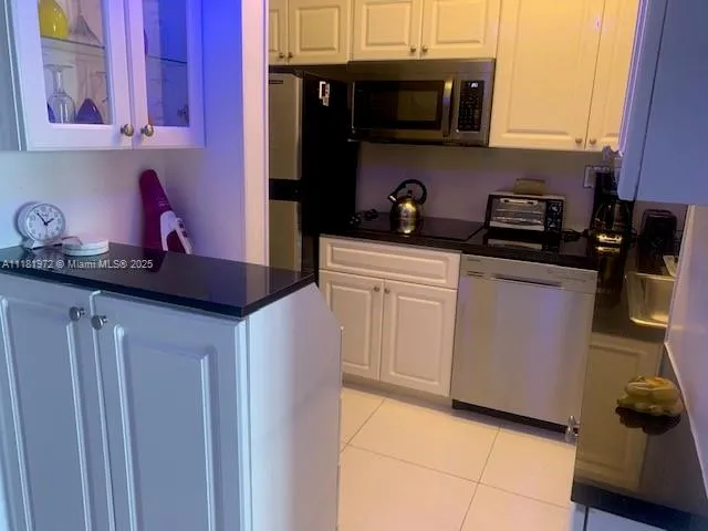 a kitchen with stainless steel appliances granite countertop a sink stove and microwave