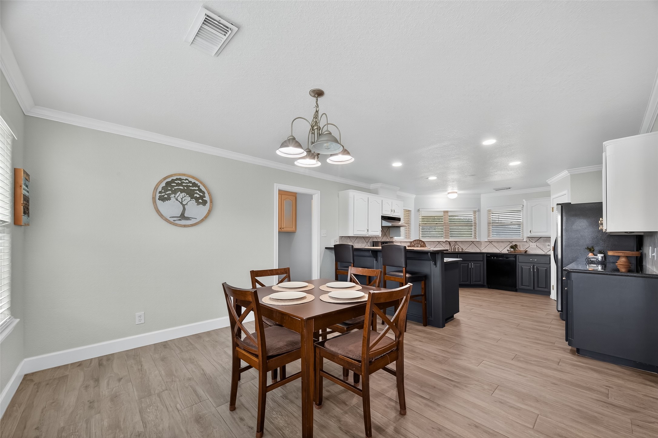 1030 Ginger Street Santa Fe, TX 77517 - Photo 11 of 50 a view of a dining room with furniture and wooden floor