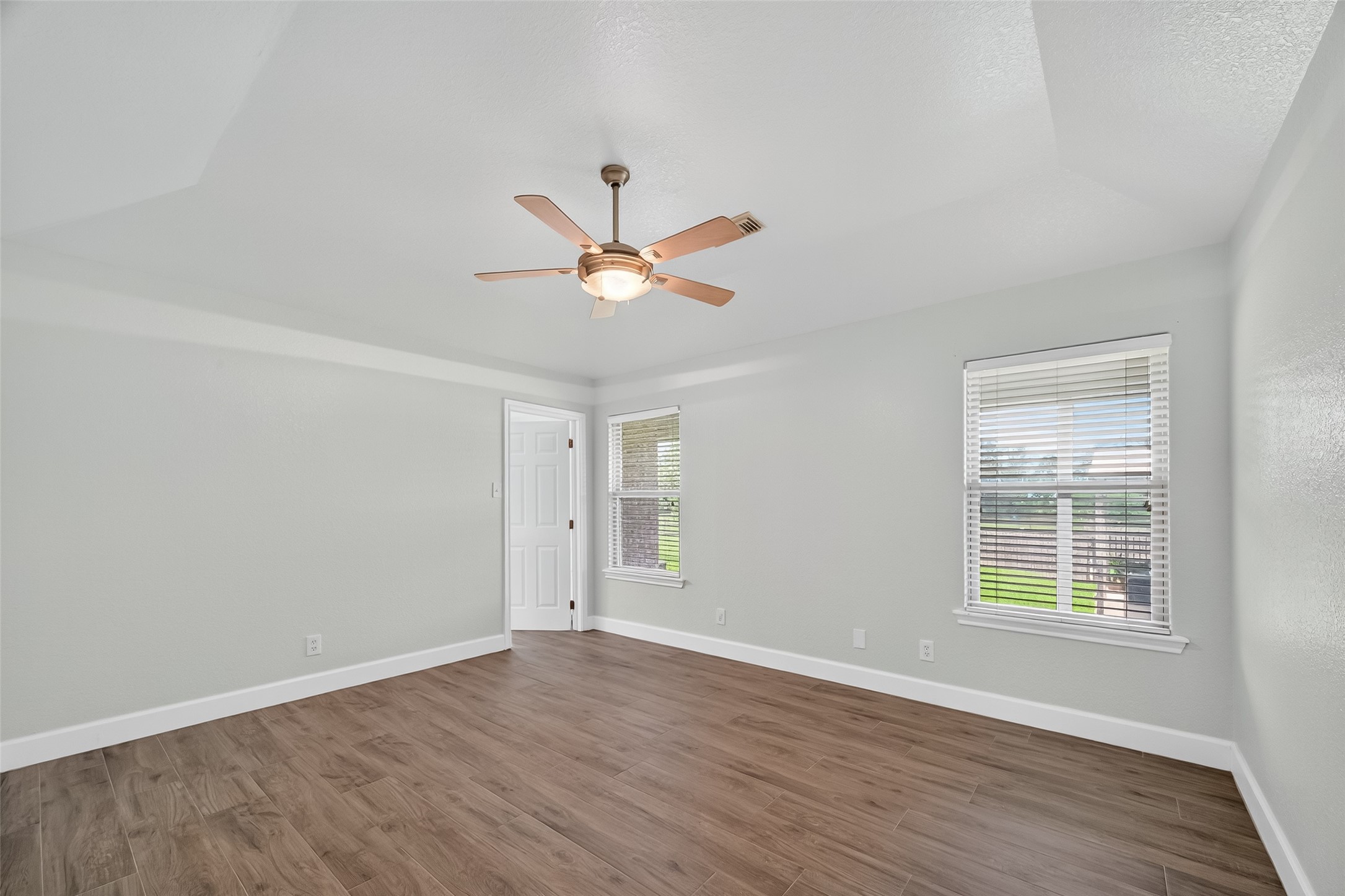 1030 Ginger Street Santa Fe, TX 77517 - Photo 23 of 50 an empty room with wooden floor and windows
