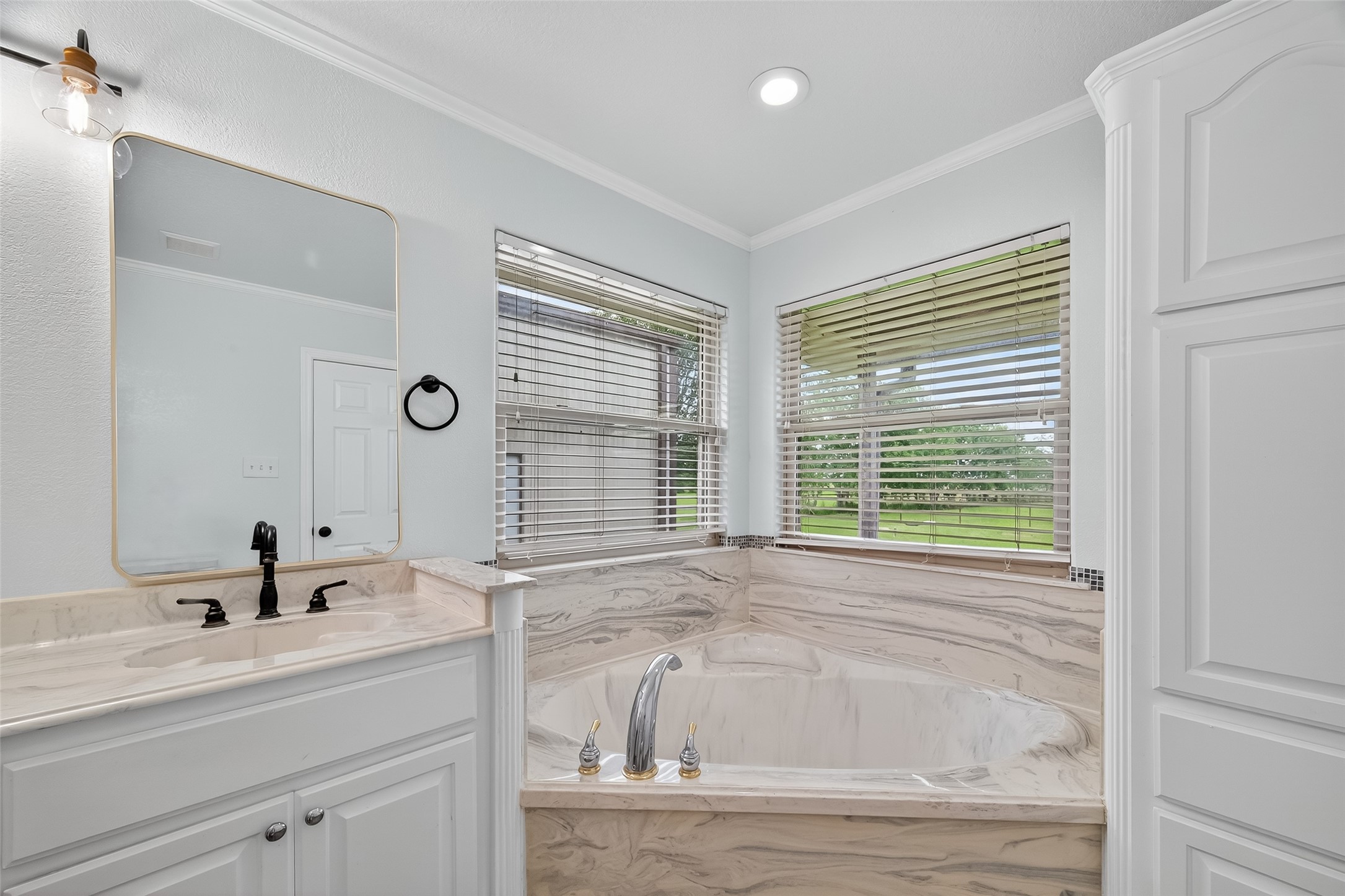 1030 Ginger Street Santa Fe, TX 77517 - Photo 27 of 50 a bathroom with a bathtub a sink a window and a shower