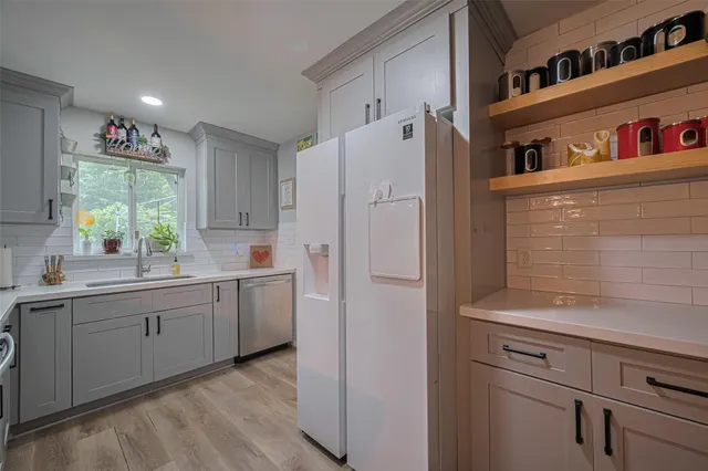 a kitchen with cabinets and window