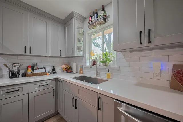 a kitchen with cabinets and window