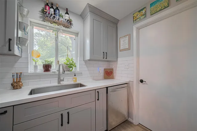 a bathroom with a sink mirror and window