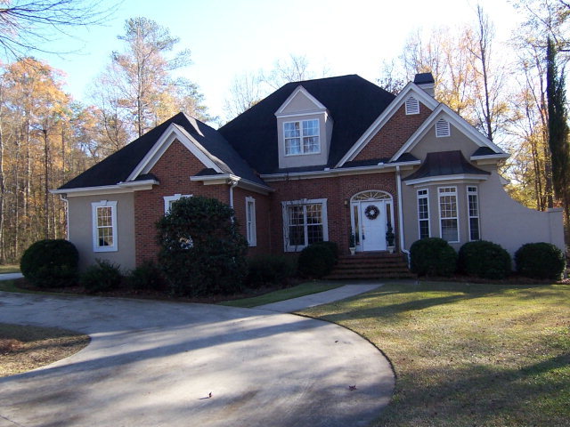 5756 Zebulon Road Macon, GA 31210 - Photo 1 of 1 a front view of a house with a garden