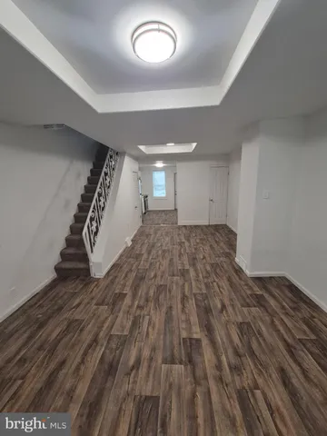 a view of a room with wooden floor