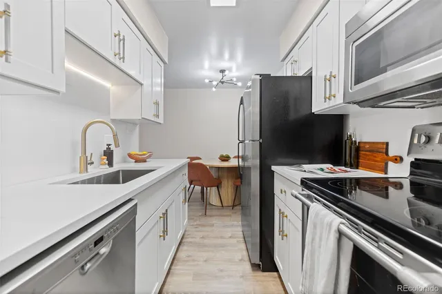 a kitchen with a sink appliances and cabinets