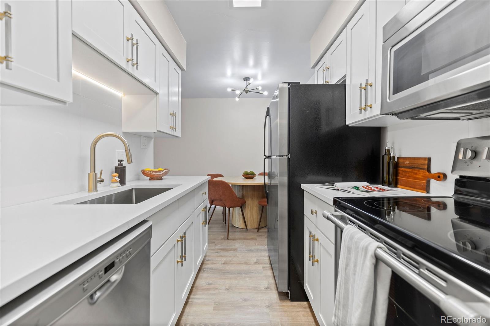 a kitchen with a sink appliances and cabinets