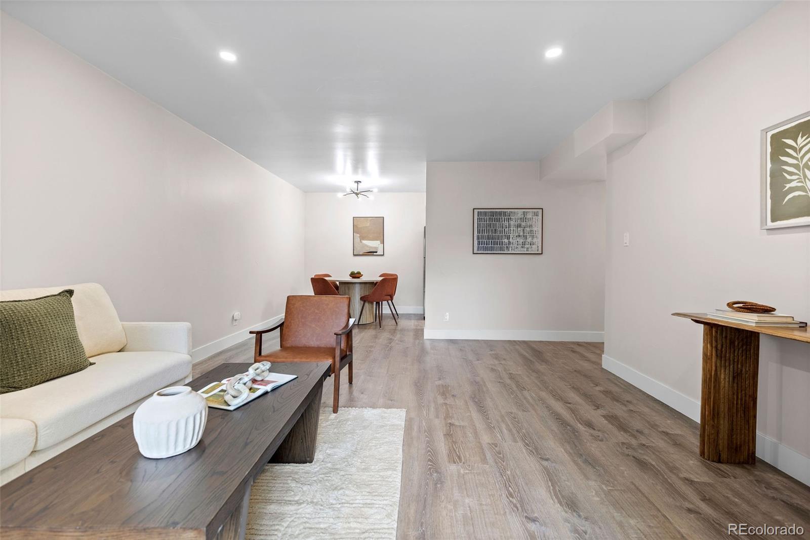 7495 East Quincy Avenue, Unit 202 Denver, CO 80237 - Photo 12 of 28 a living room with furniture and a wooden floor