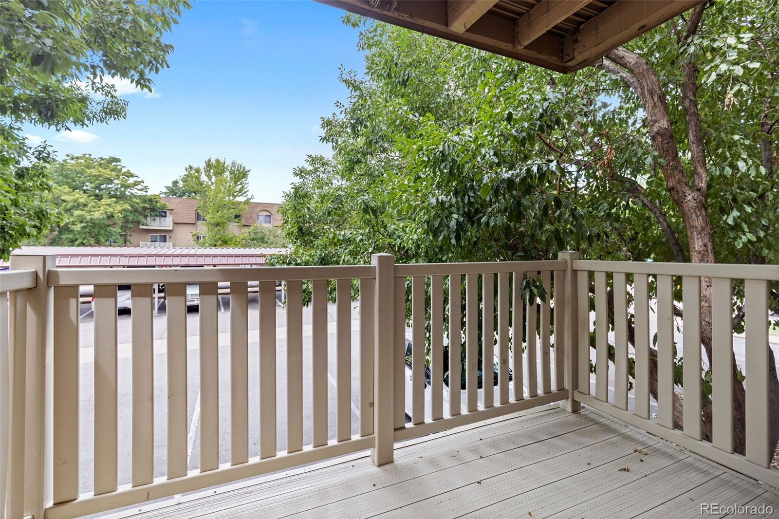 7495 East Quincy Avenue, Unit 202 Denver, CO 80237 - Photo 14 of 28 a balcony with wooden floor and fence