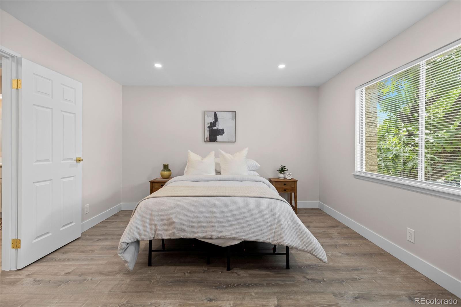 7495 East Quincy Avenue, Unit 202 Denver, CO 80237 - Photo 16 of 28 a bedroom with a bed and a white wall painting