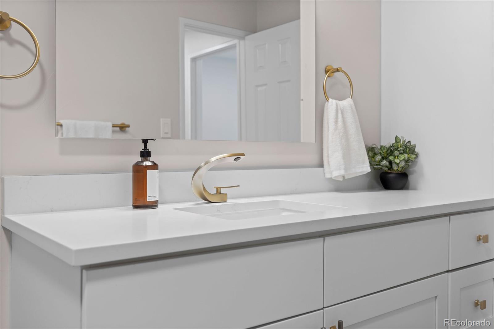 7495 East Quincy Avenue, Unit 202 Denver, CO 80237 - Photo 21 of 28 a bathroom with a sink and a mirror