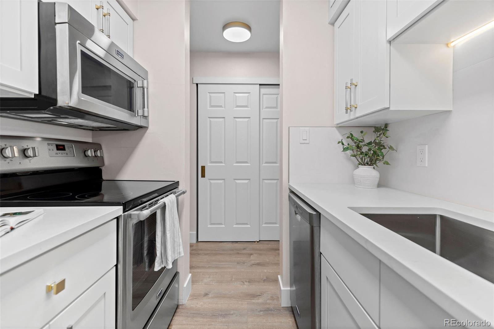 7495 East Quincy Avenue, Unit 202 Denver, CO 80237 - Photo 4 of 28 a kitchen with a stove and a microwave