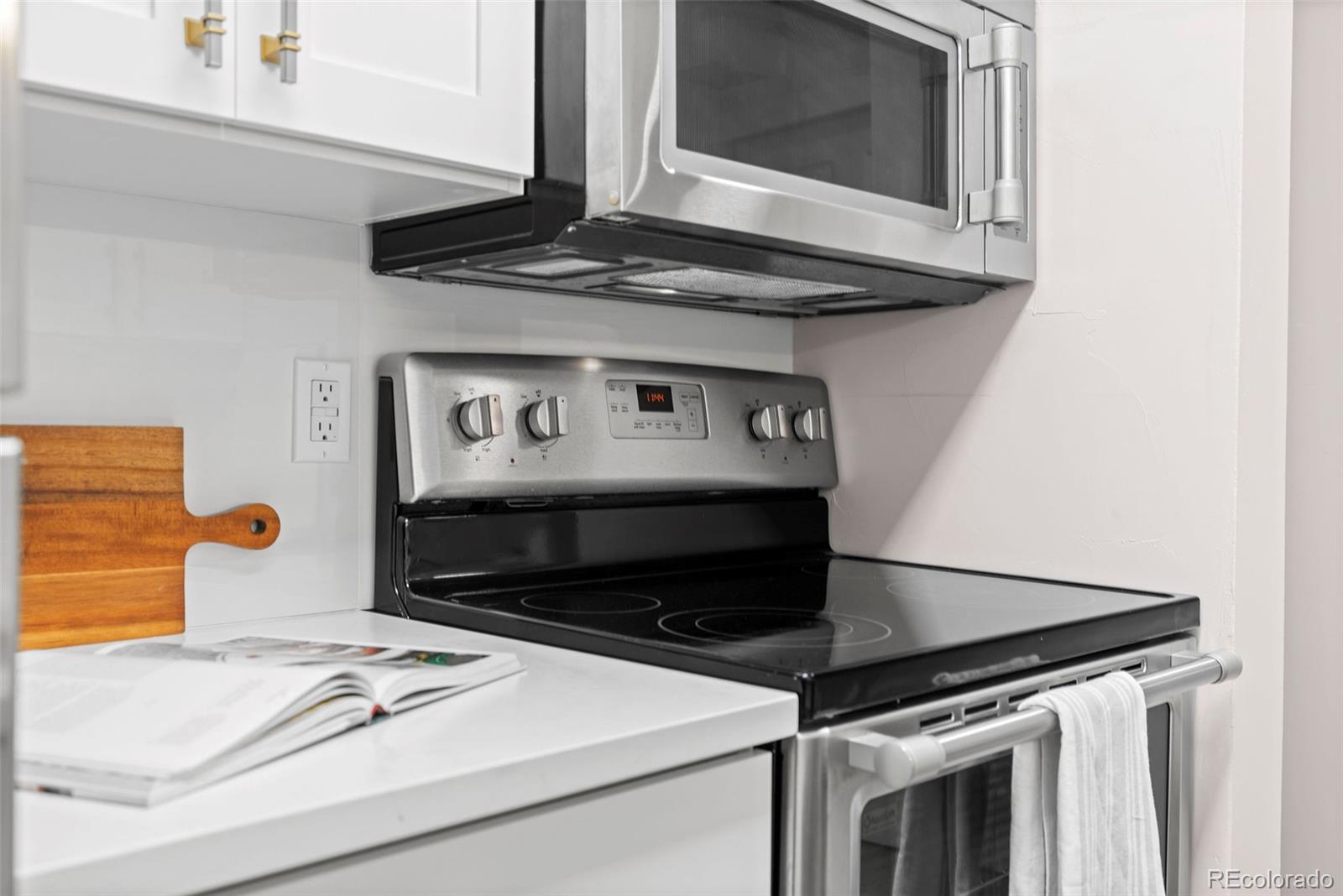 7495 East Quincy Avenue, Unit 202 Denver, CO 80237 - Photo 5 of 28 a kitchen with a stove and a microwave