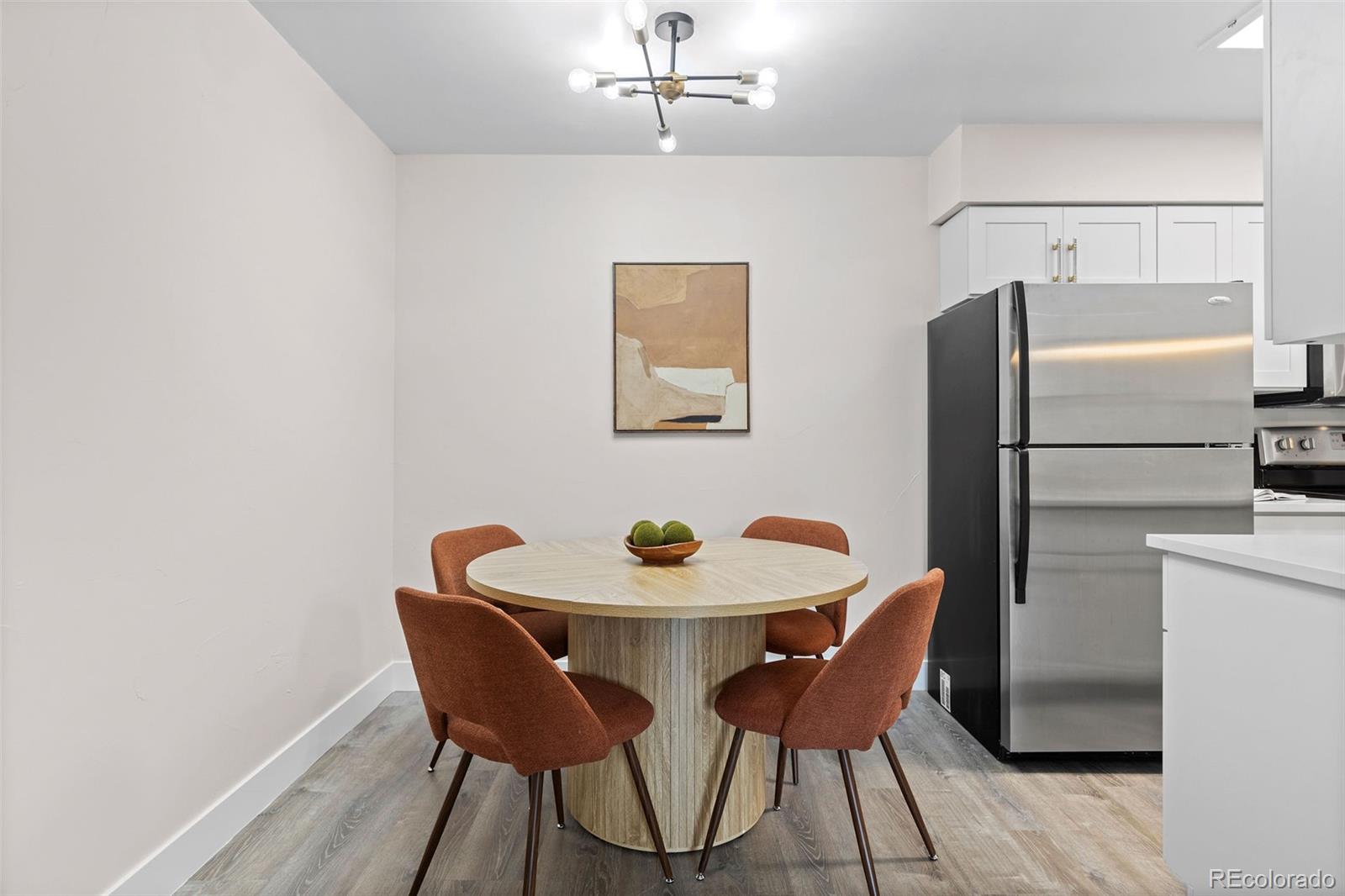 7495 East Quincy Avenue, Unit 202 Denver, CO 80237 - Photo 6 of 28 a dining room with furniture and wooden floor