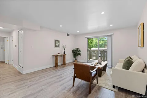 a living room with furniture and a potted plant