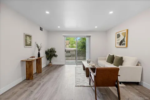 a living room with furniture and a potted plant