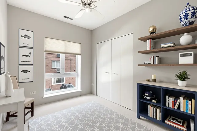 a living room with furniture and a book shelf