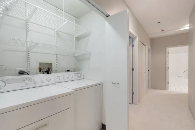 a view of storage and utility room with washer and dryer