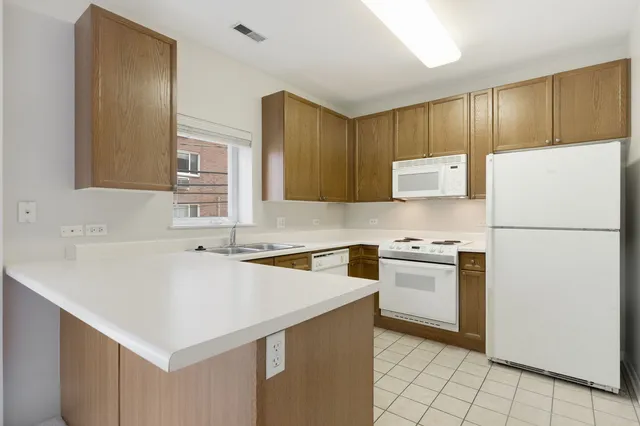 a kitchen with a stove a sink and a refrigerator