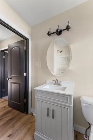 a bathroom with a sink vanity and a mirror