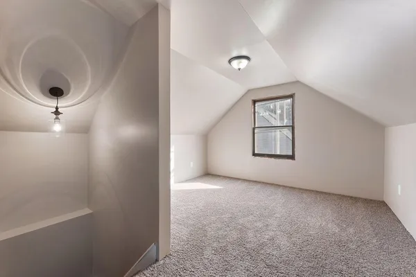 an empty room with windows and cabinet