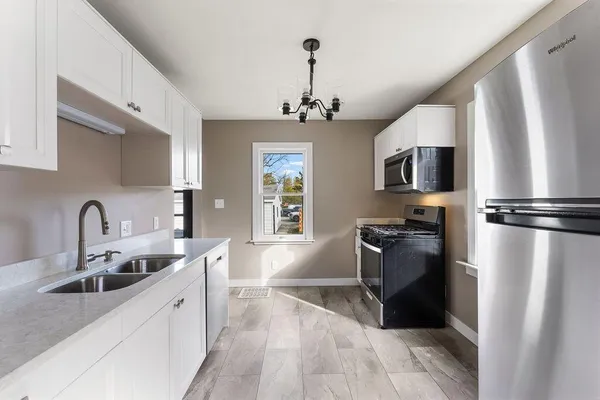 a kitchen with stainless steel appliances a sink stove and refrigerator