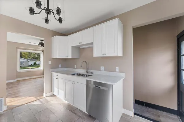 a kitchen with stainless steel appliances granite countertop a sink and cabinets