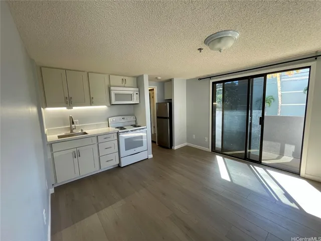 a kitchen with granite countertop cabinets and window