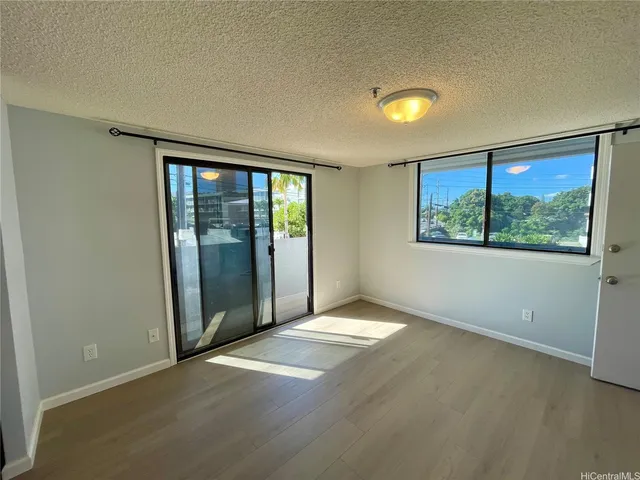 an empty room with windows and closet