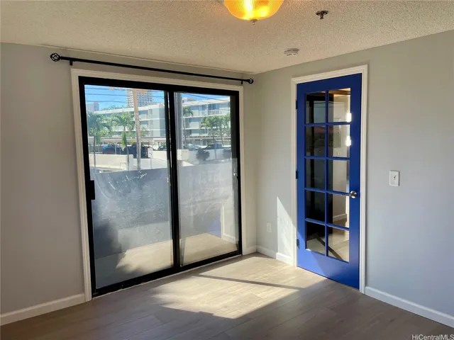 an empty room with sliding glass door and shower