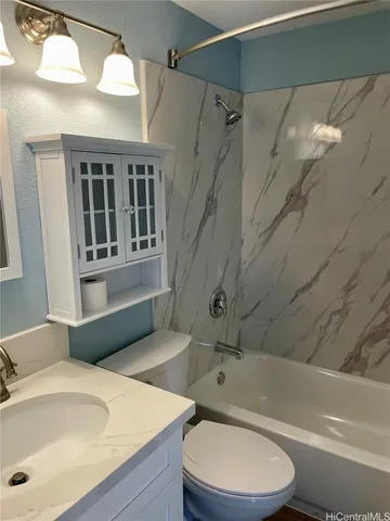 a bathroom with a sink a toilet and bathtub