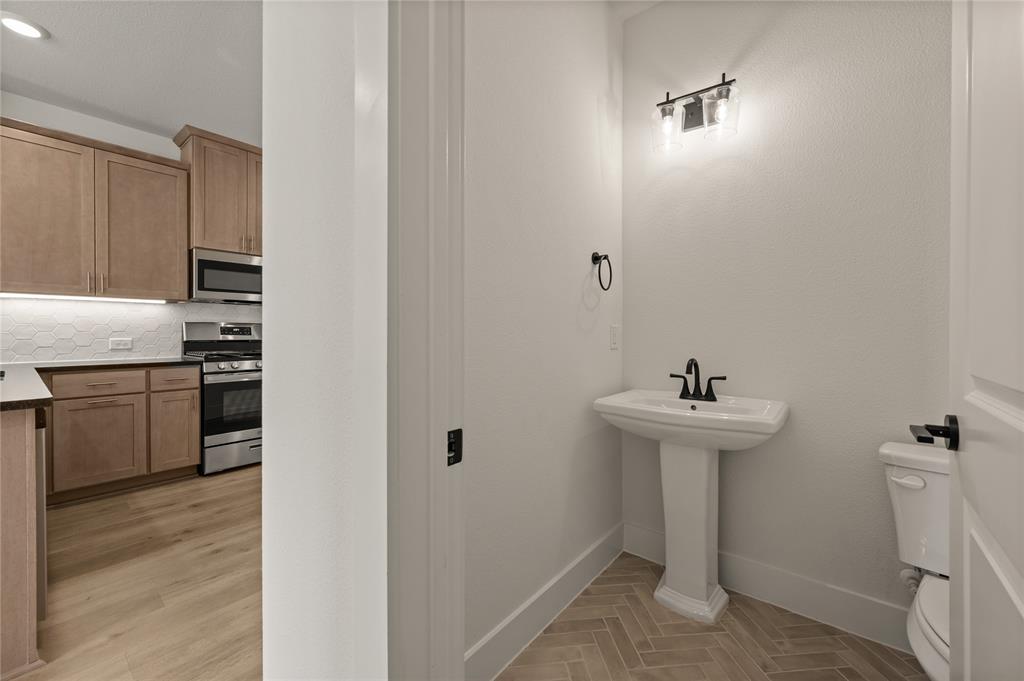 2550 Brunswick Way Allen, TX 75013 - Photo 13 of 24 a bathroom with a sink a toilet and dryer