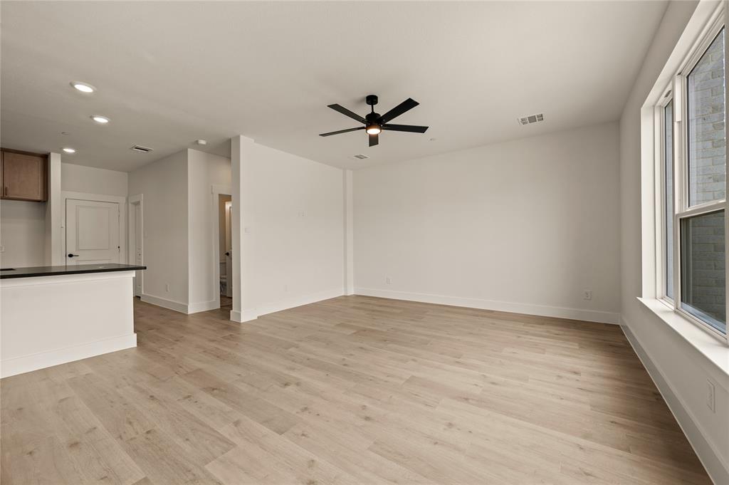 2550 Brunswick Way Allen, TX 75013 - Photo 5 of 24 wooden floor in an empty room with a window