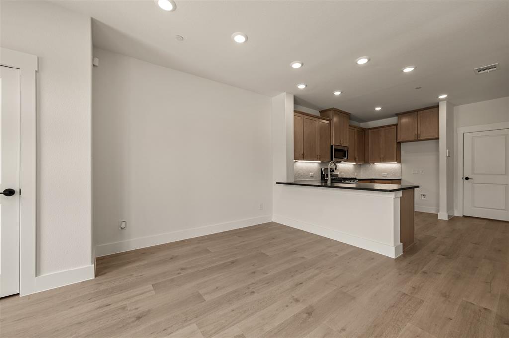2550 Brunswick Way Allen, TX 75013 - Photo 7 of 24 a view of kitchen with kitchen island granite countertop stainless steel appliances counter space and wooden floor