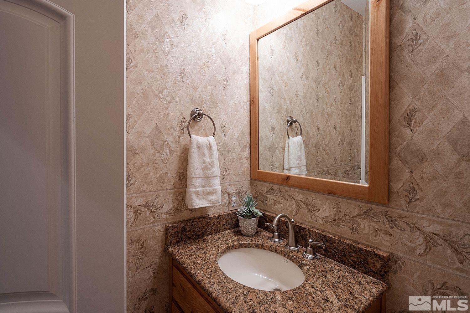 4530 Lousetown Road Reno, NV 89521 - Photo 14 of 39 a bathroom with a granite countertop sink and a mirror