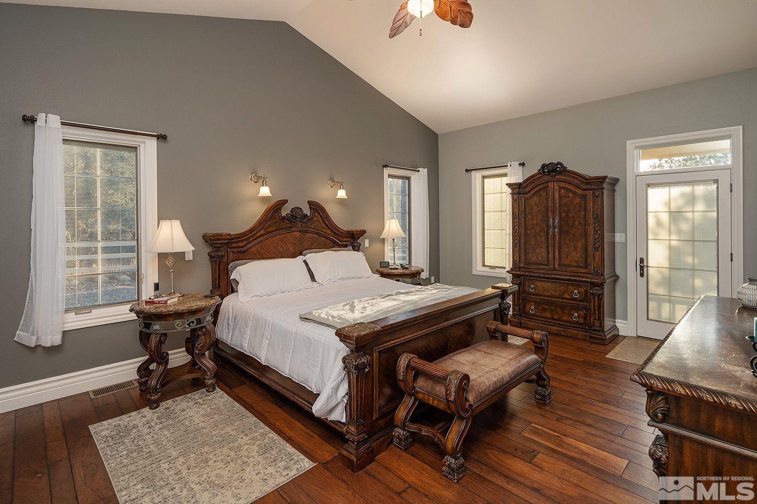 4530 Lousetown Road Reno, NV 89521 - Photo 16 of 39 a bedroom with a bed a dresser and wooden floor