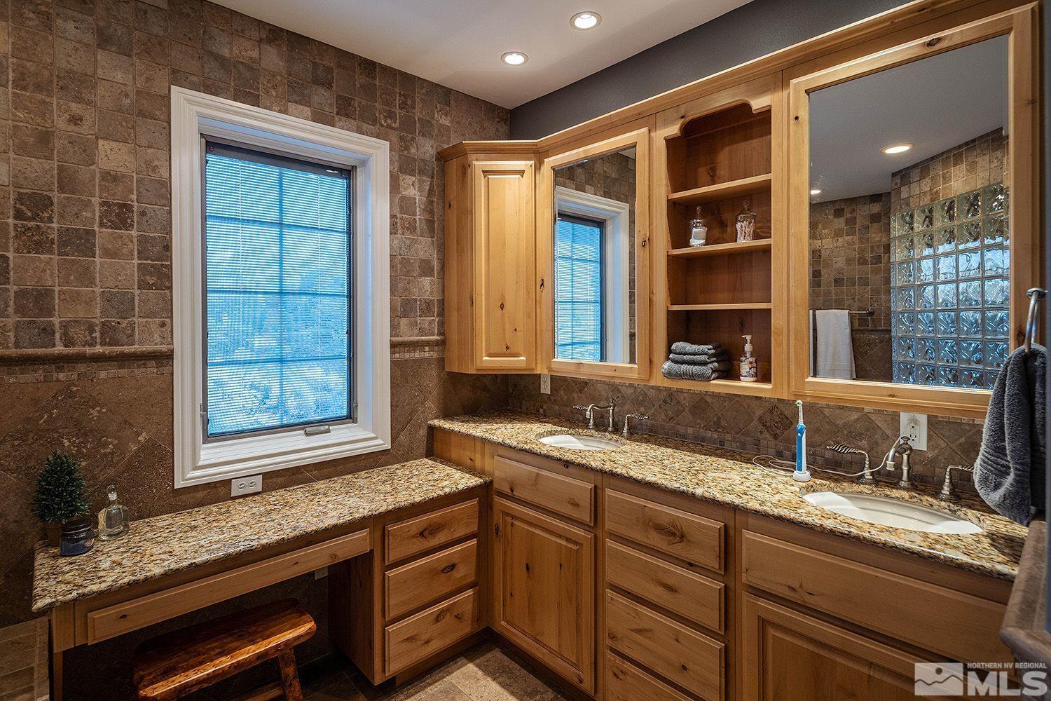 4530 Lousetown Road Reno, NV 89521 - Photo 18 of 39 a view of a granite countertop sink and dishwasher with wooden cabinet