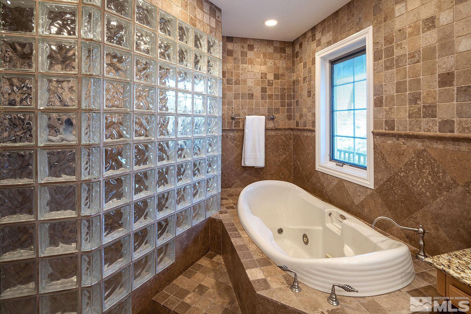 4530 Lousetown Road Reno, NV 89521 - Photo 19 of 39 a bathroom with a bathtub and a shower