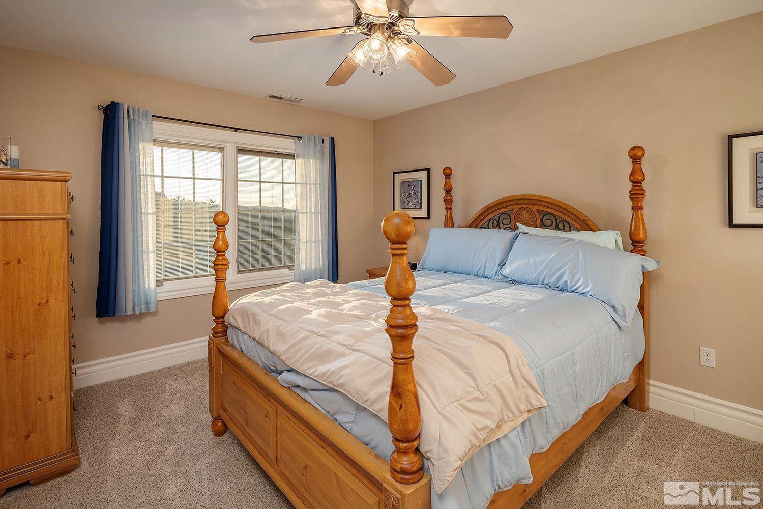 4530 Lousetown Road Reno, NV 89521 - Photo 21 of 39 a bedroom with a bed and a chandelier