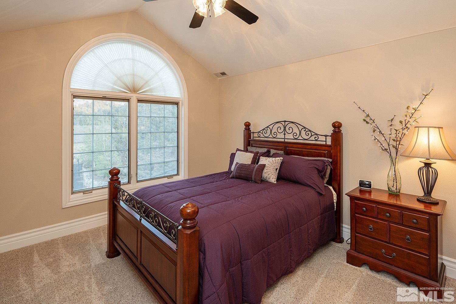 4530 Lousetown Road Reno, NV 89521 - Photo 24 of 39 a bedroom with a bed and a chandelier
