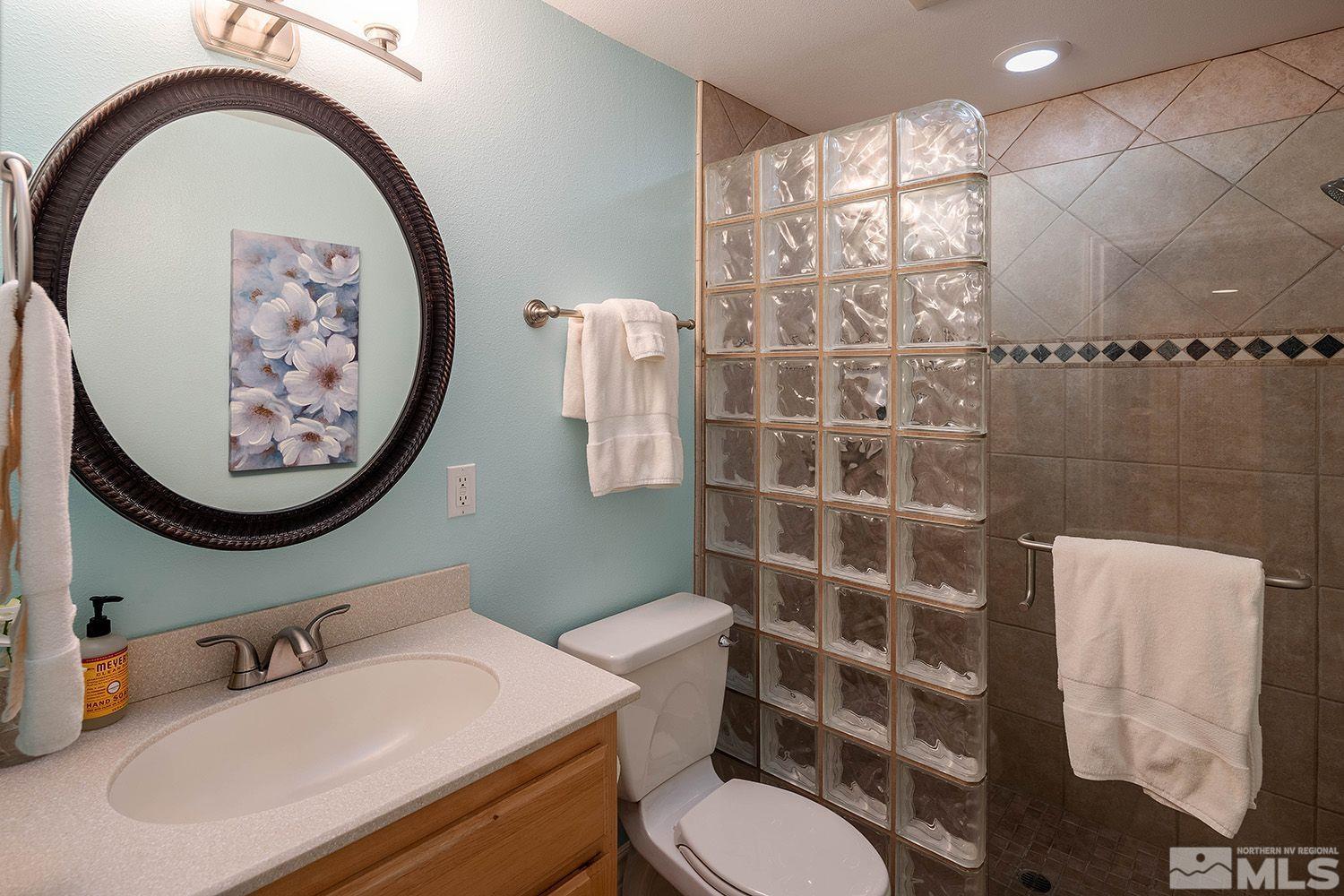 4530 Lousetown Road Reno, NV 89521 - Photo 25 of 39 a bathroom with a toilet sink and mirror