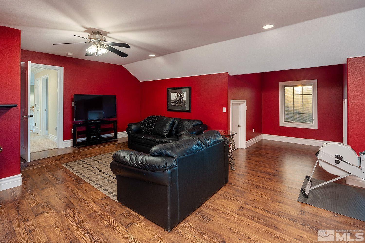 4530 Lousetown Road Reno, NV 89521 - Photo 28 of 39 a living room with furniture a red lamp and a flat screen tv