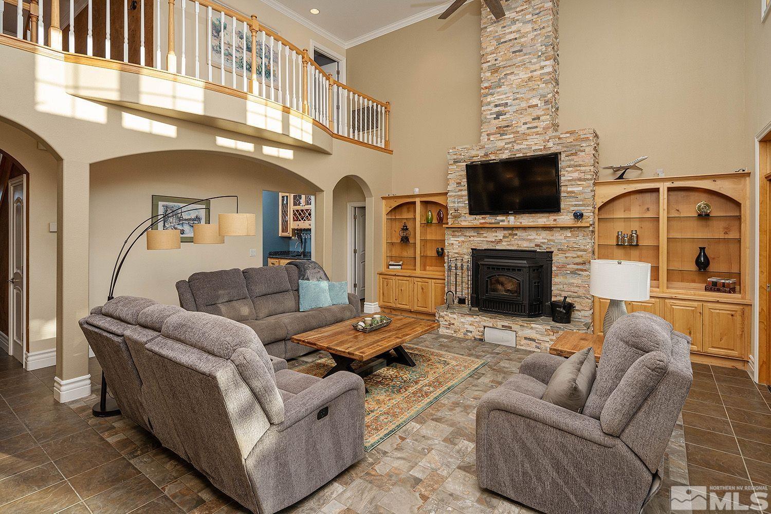 4530 Lousetown Road Reno, NV 89521 - Photo 4 of 39 a living room with furniture a flat screen tv and a fireplace