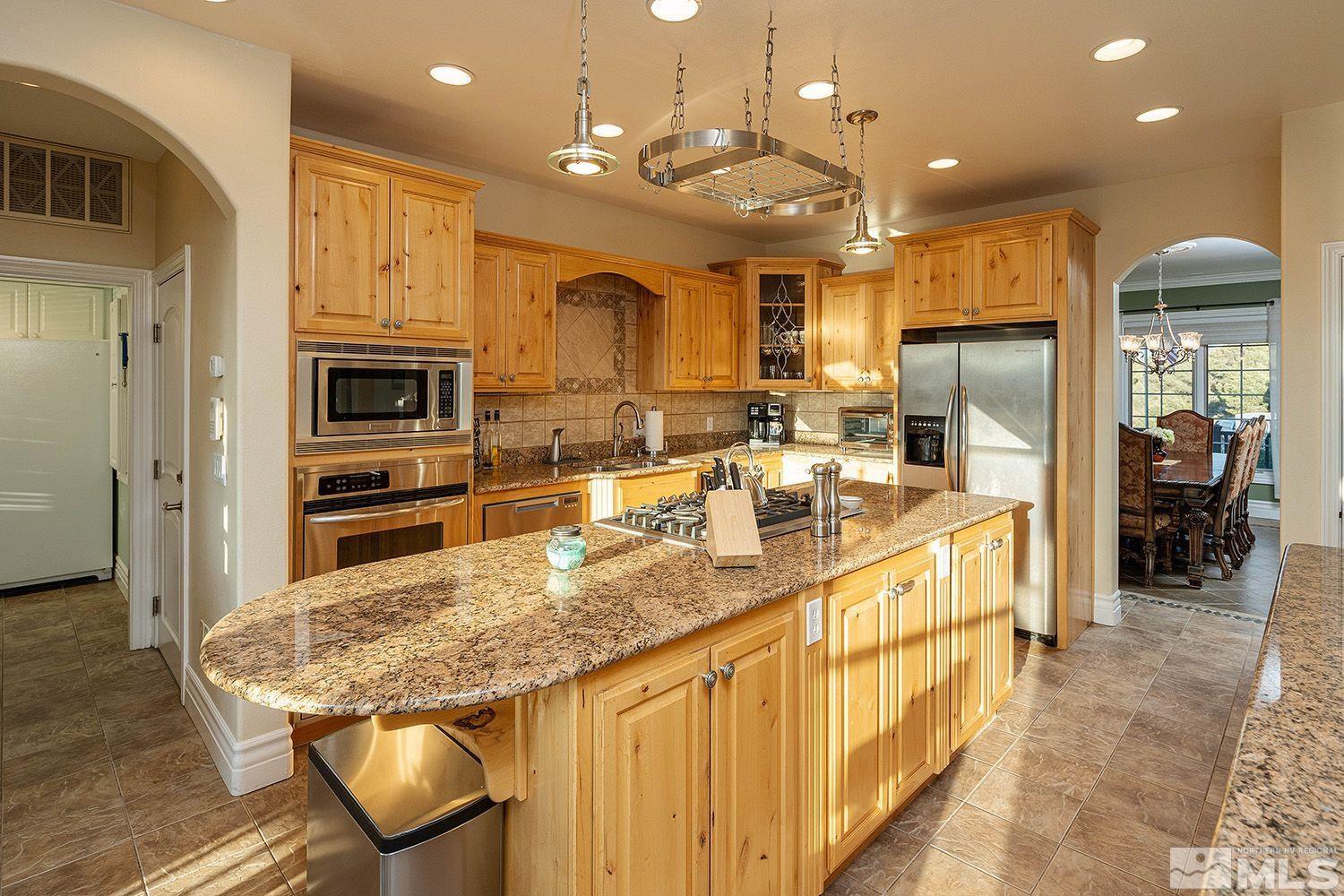4530 Lousetown Road Reno, NV 89521 - Photo 8 of 39 a kitchen with stainless steel appliances granite countertop a kitchen island a stove and a sink